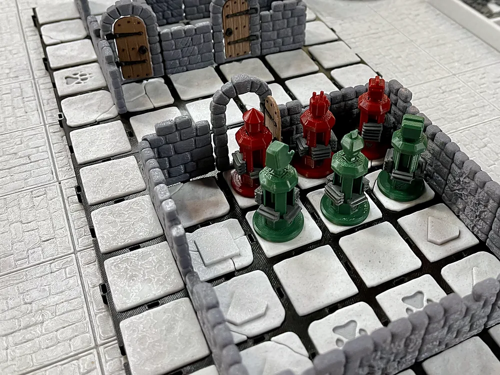 A Dungeon Dive game in progress on a StageTop table at the show: stone walls, hero and monster figurines and a treasure token